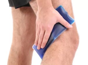 application d'une compresse de froid instantané derrière le genou